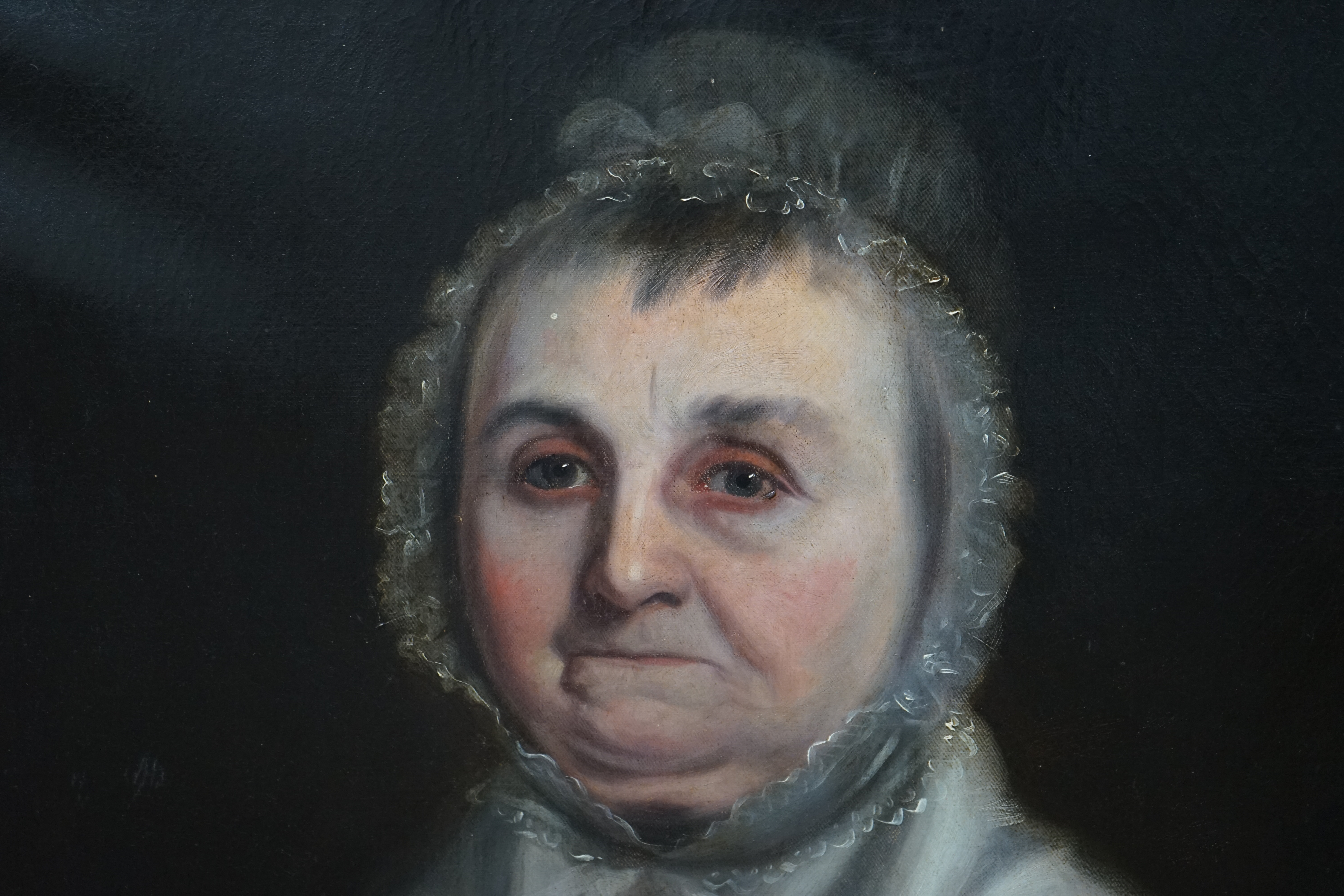 Late 18th / early 19th century English School, oil on canvas, Head and shoulders portrait of an elderly lady wearing a bonnet, unsigned, 74 x 62cm, label verso, ornately framed. Condition - fair, original canvas sagging